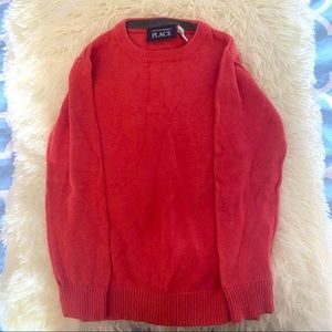 Children place sweater